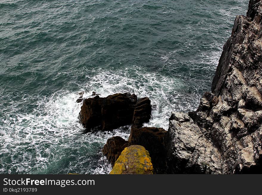 Rock Mountain Beside Body of Water