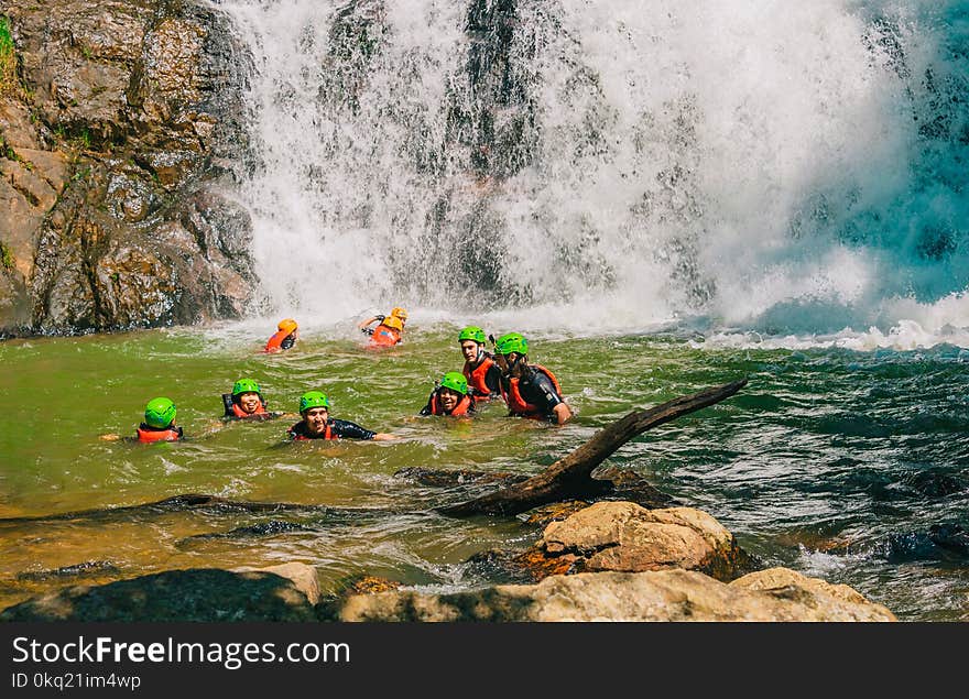 Group of People on Body of Water