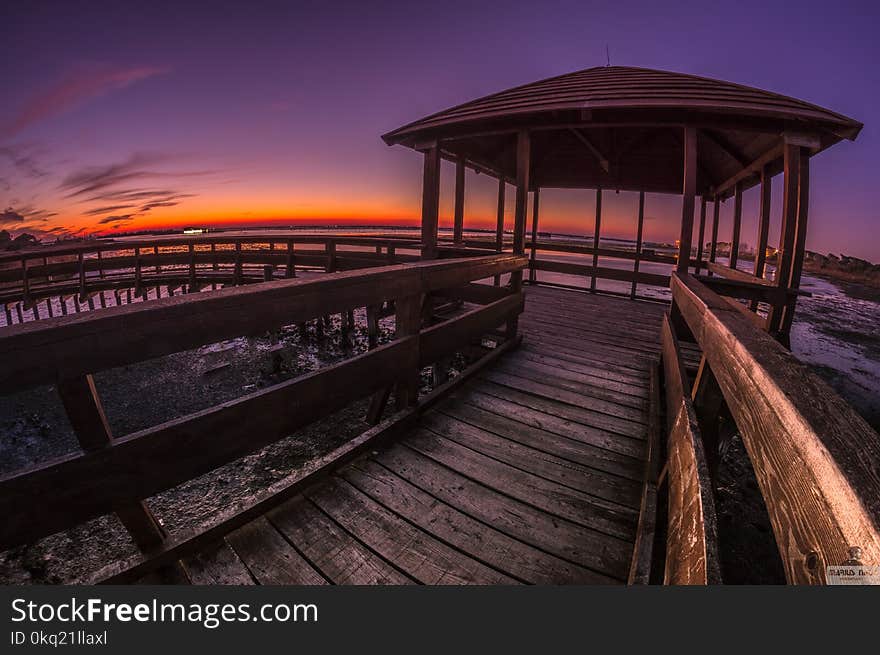 Brown Wooden Pagoda Under Golden Sky