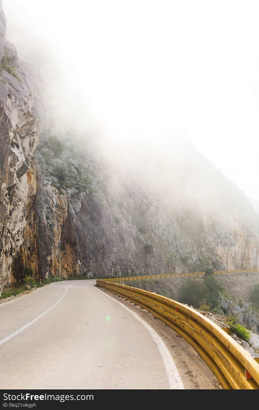 Photography of Road Near Foggy Mountain