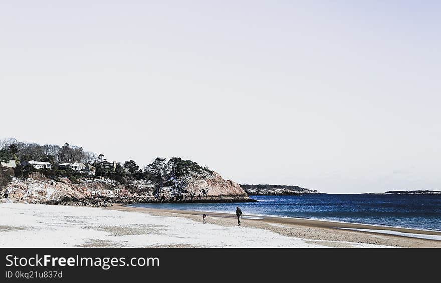 Person Walking on Seashore