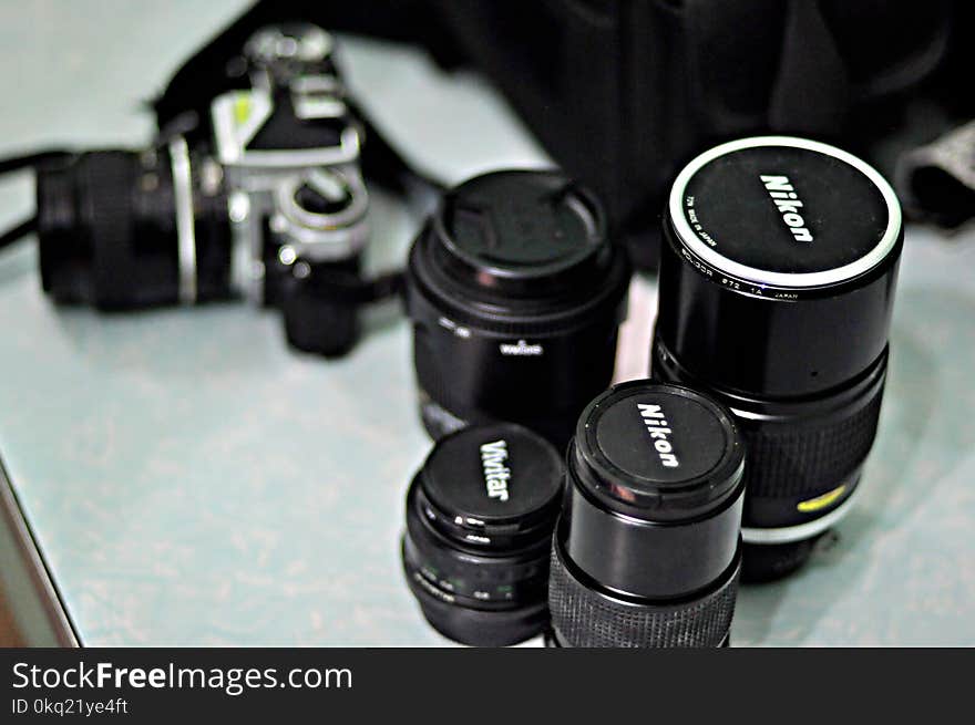 Four Black Nikon Zoom Camera Lens