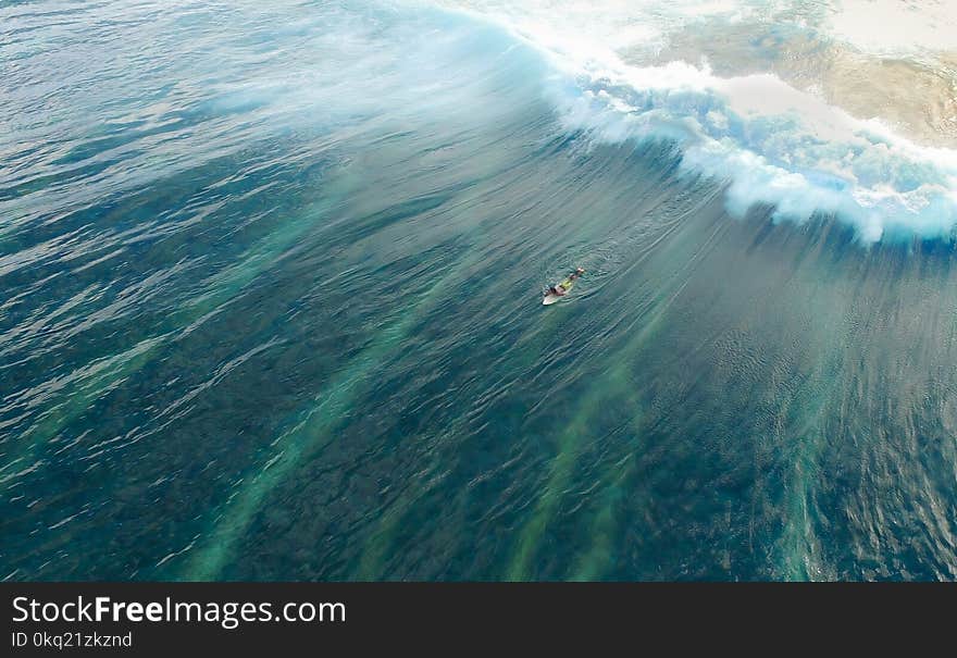 Man on Surfboard Surfing on Wave