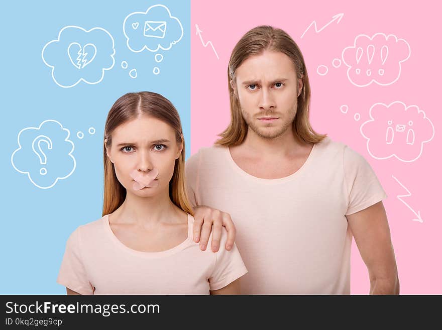 Pregnancy. Young pregnant women standing with a sticking plaster on the mouth and her serious calm husband putting his hand on her shoulder. Pregnancy. Young pregnant women standing with a sticking plaster on the mouth and her serious calm husband putting his hand on her shoulder