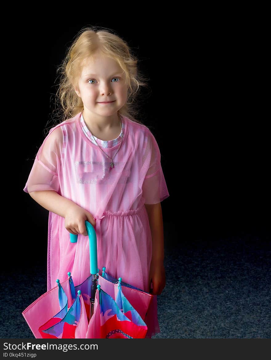 A nice little girl with an umbrella on a black background. A nice little girl with an umbrella on a black background.