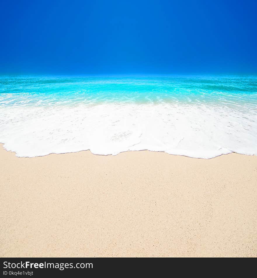 Beautiful Tropical beach with Soft wave of blue ocean, white sand and sky. Summer travel holiday background concept. Sea panorama with copyspace