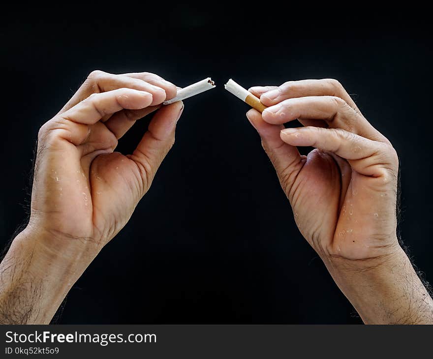 Male hand crushing cigarette on black background, Concept Quitting smoking,World No Tobacco Day.