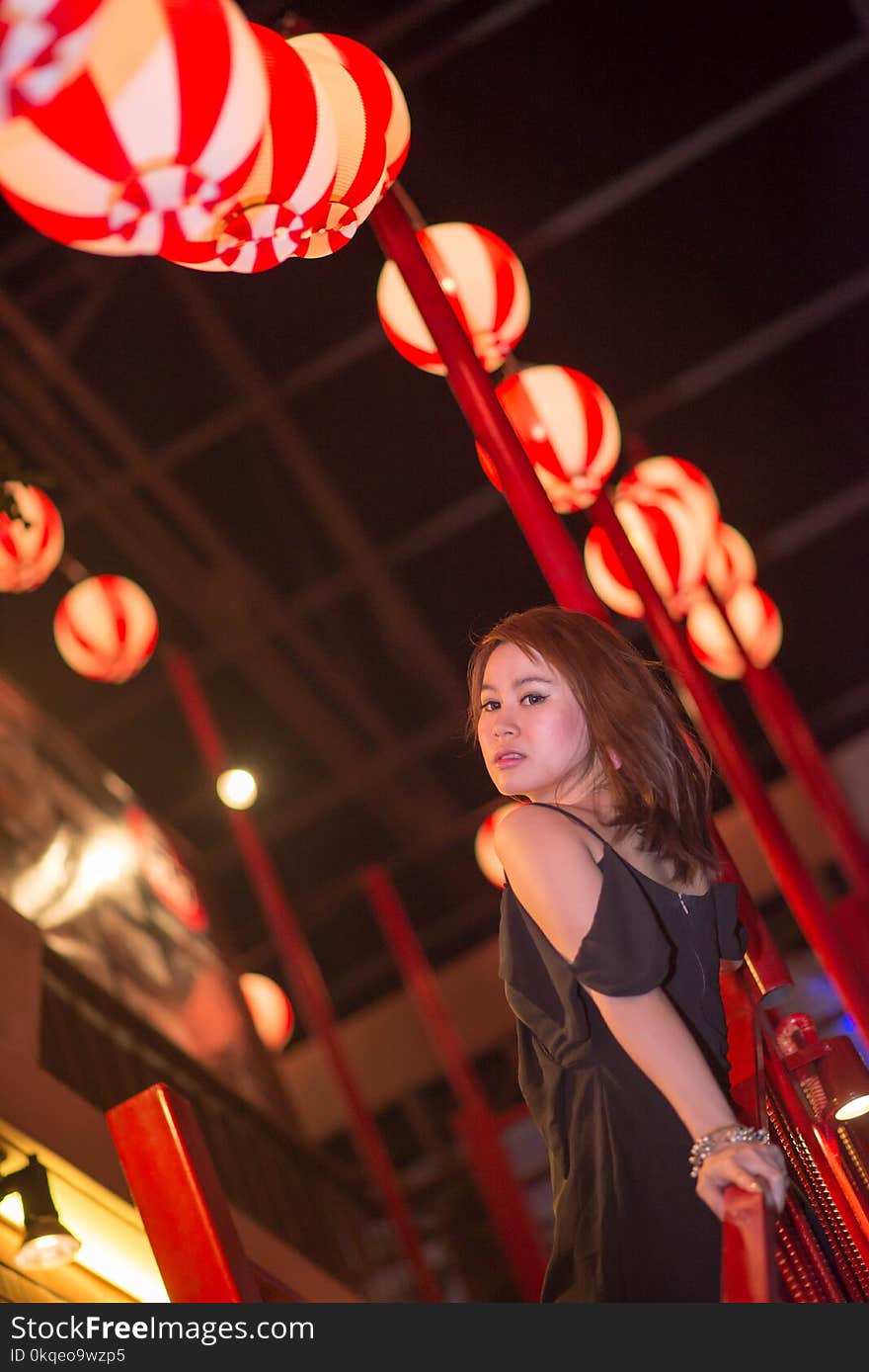 Young beautiful woman outdoor portrait,wear a luxury black dress in nightlife.