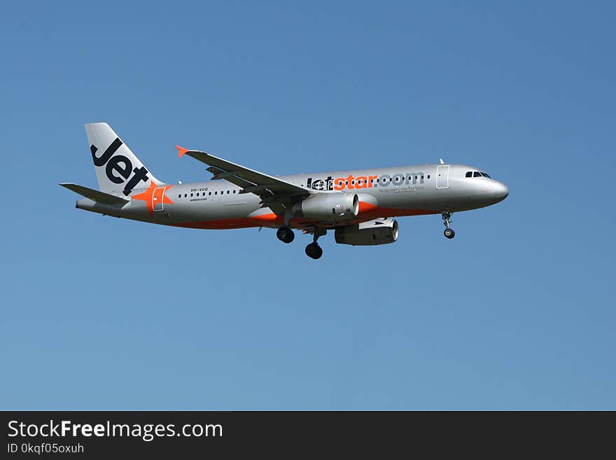 Jetstar Plane Flight Under Blue Sky