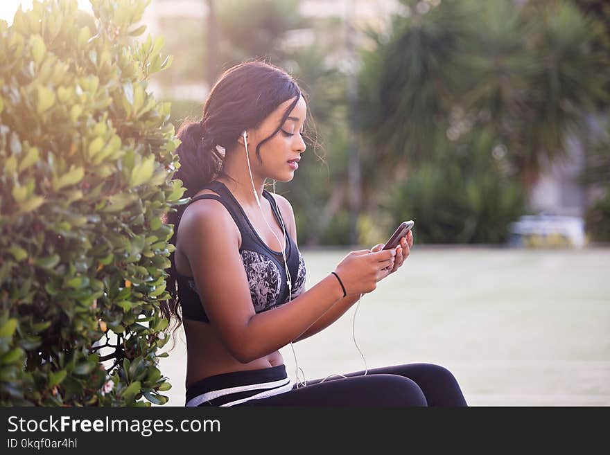 Woman in Black Crop Top Holding Smartphone