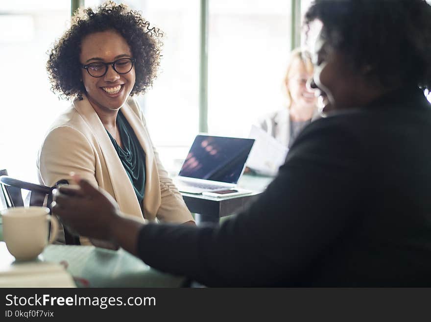 Woman Sitting on Chair Near Laptop Computer