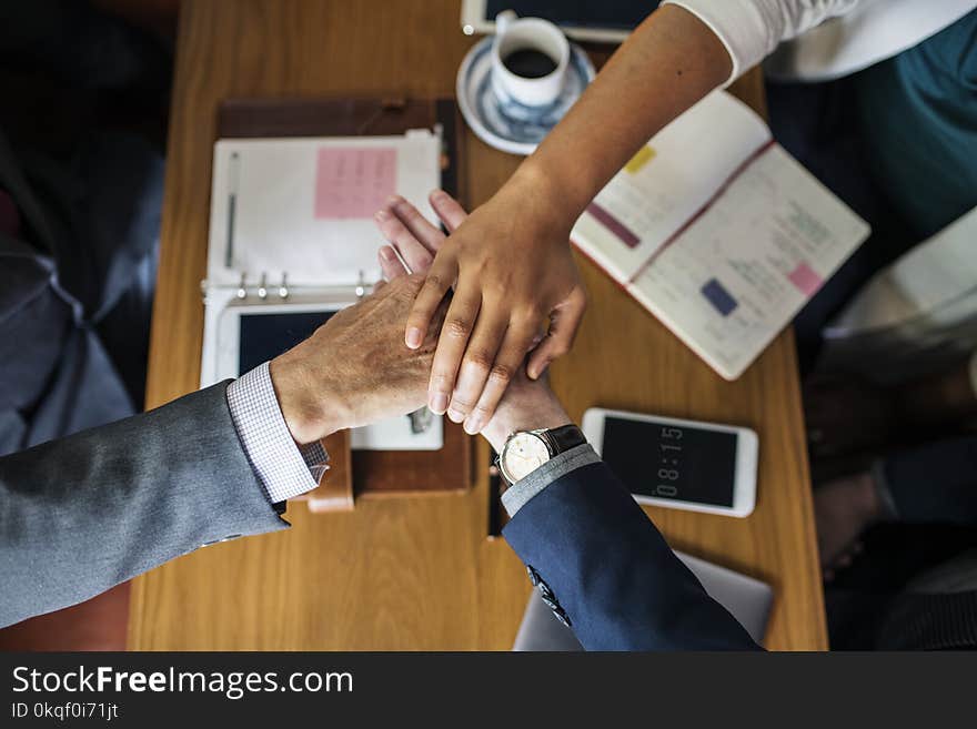 Three Person&#x27;s Hands on Center Near Table