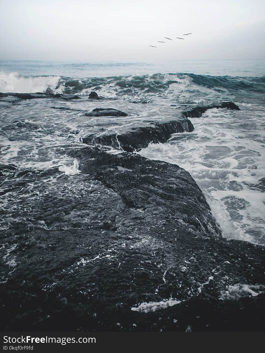 Landscape Photography of Body of Water Smashing in the Rocks