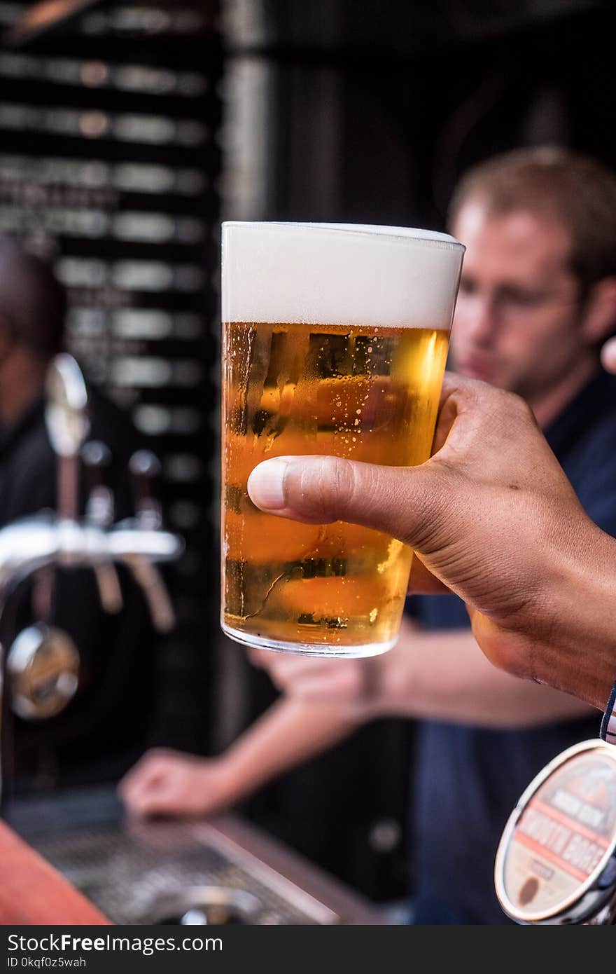 Person Holding Glass Filled With Liqour