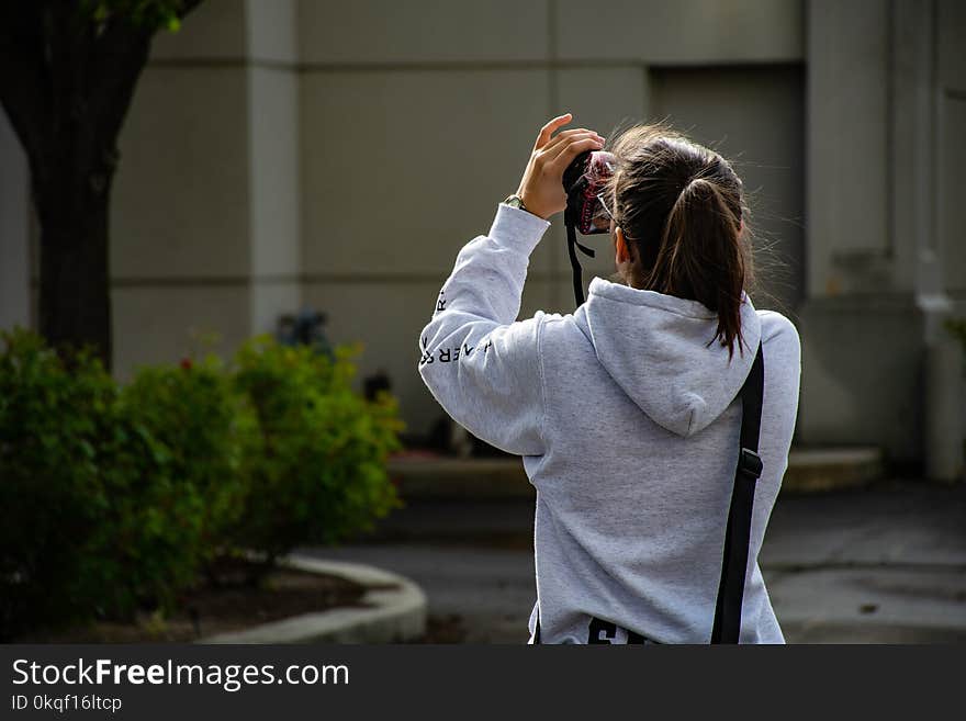 Photo of Girl Holding Dslr Camer and Taking Photo