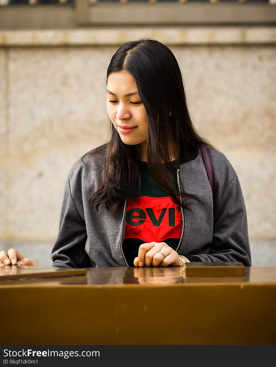 Woman Wearing Black Levis Crew-neck Shirt and Gray Zip-up Jacket