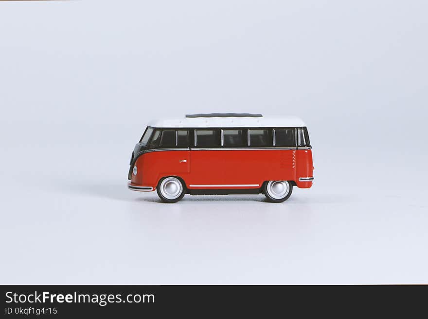 Red Volkswagen T1 Die-cast Toy on White Surface