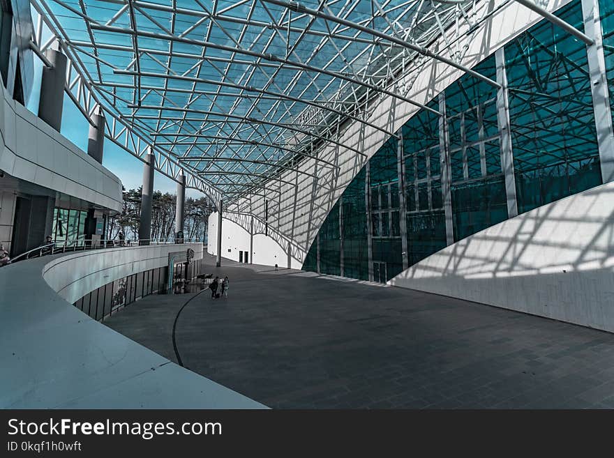 Two Person Standing Near White Concrete Building