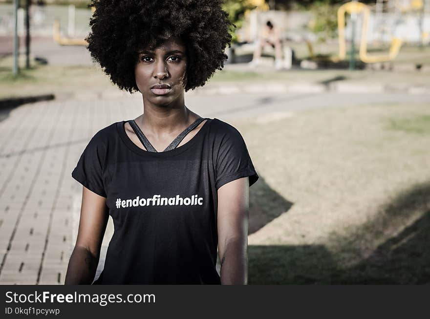 Woman Wearing Black T-shirt Standing Near Playground