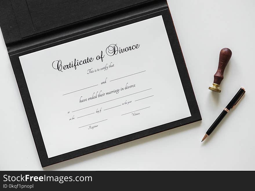 Certificate of Divorce Paper Beside Black Ballpoint Pen