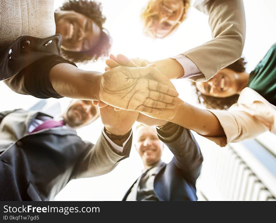 Low Angle Photo of People Doing Huddle Up