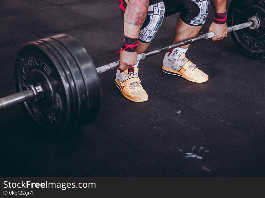 Person Lifting Black and Gray Metal Barbell