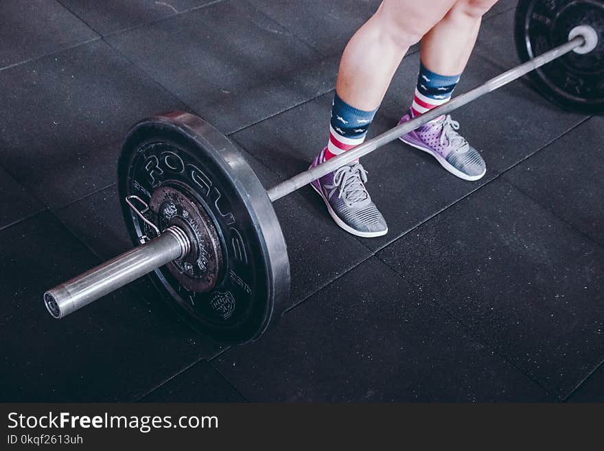 Person Standing Near Black Barbell