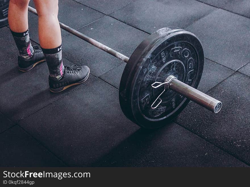 Person Standing Near Black Barbell