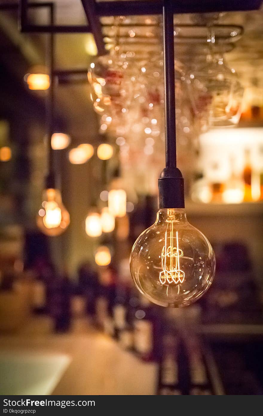 Vintage lamp bulb with bar or cafe night abstract background