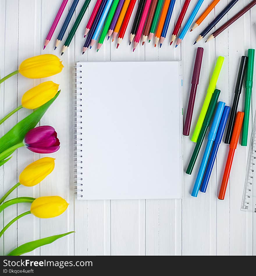 Blank paper and colorful pencils on old wooden table