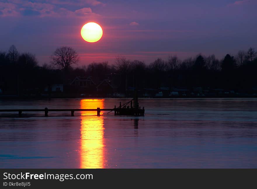 Boat Dock on Body of Water during Golden Hour