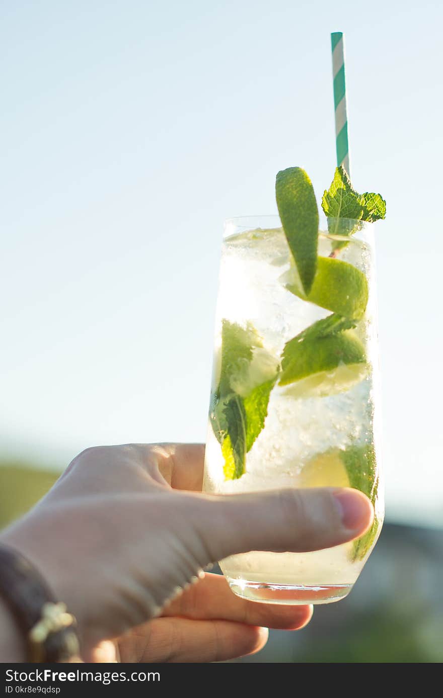 Person Holding Glass Filled With Lemonade