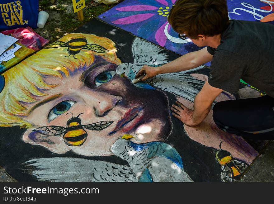 Man Painting Face of Human and Bird