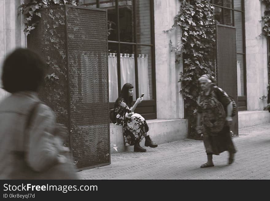 Woman Sitting on Gray Concrete Front Step of House