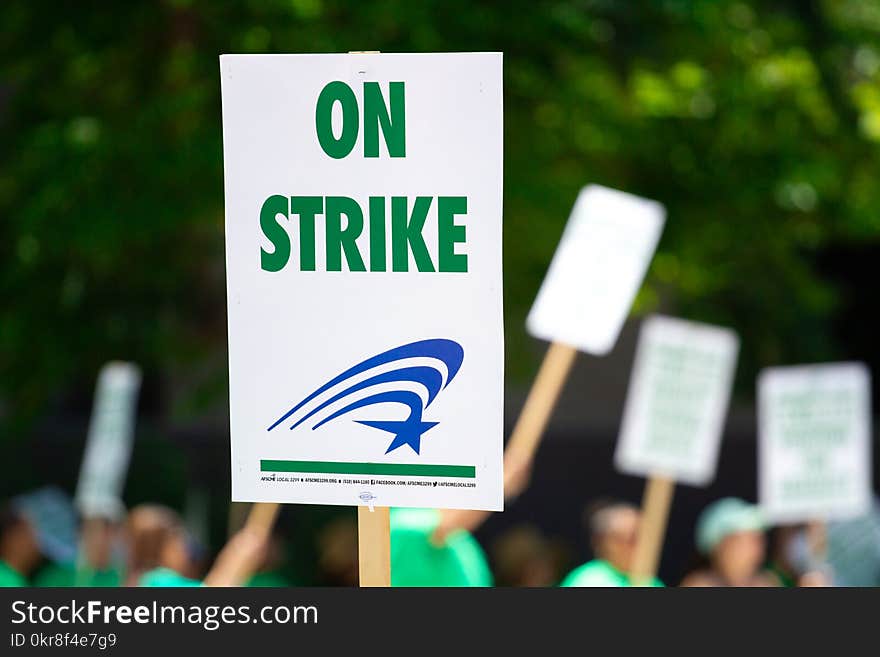 People Rallying Carrying on Strike Signage