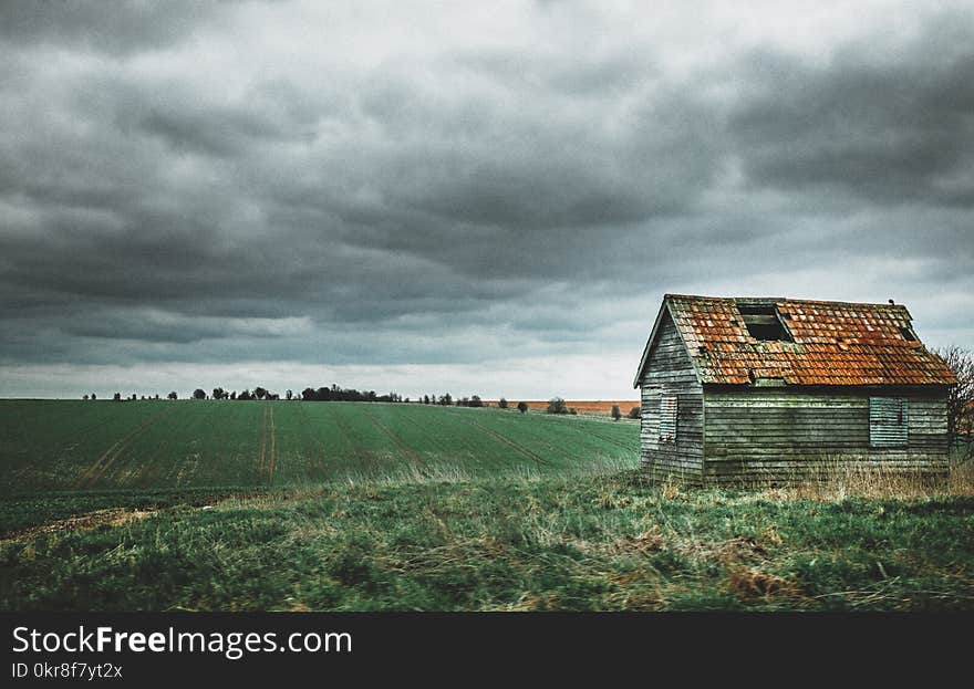 Grey and Brown House Near Green Grass Field