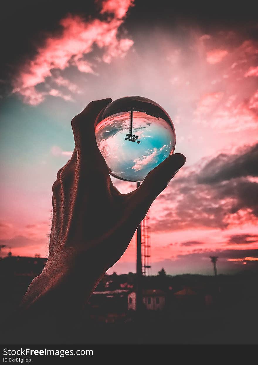 Person Holding Clear Glass Ball