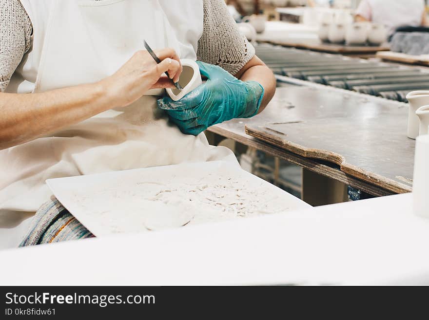 Person Wearing Green Glove While Carving