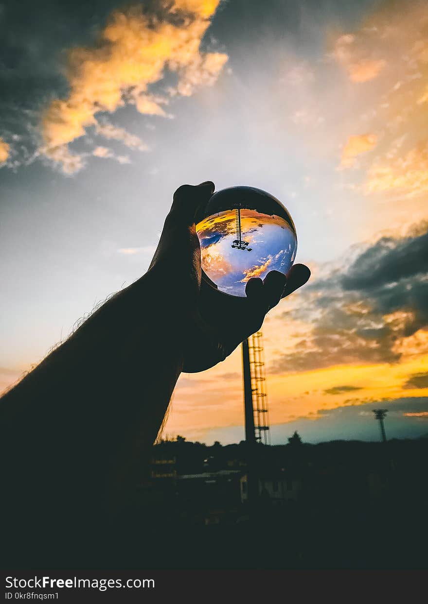 Person Holding Glass Ball