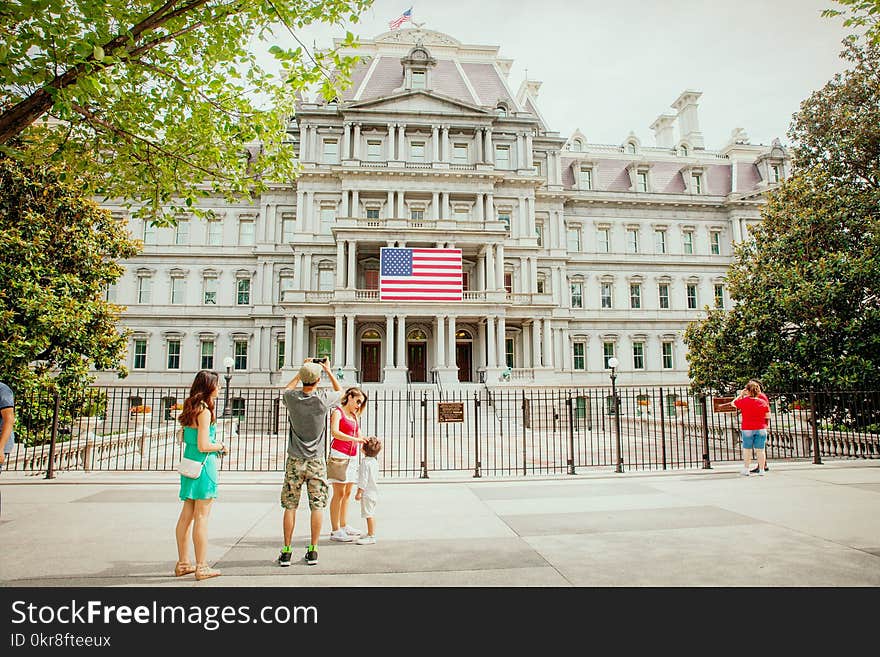 Photo of Group of People Near White Concrete Building White Flag of U.s.a.