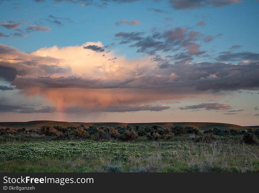 White Clouds Above Hill during Golden Hour