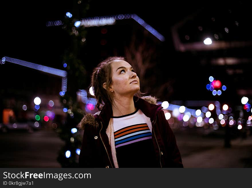 Woman Looking Up during Night Time