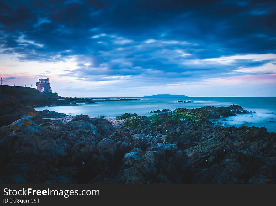 Lighthouse on Cliff Near Sea