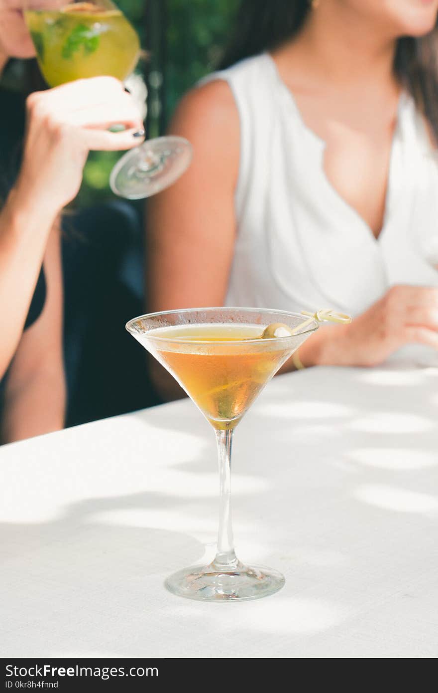 Clear Cocktail Glass Filled With Liquor on White Table