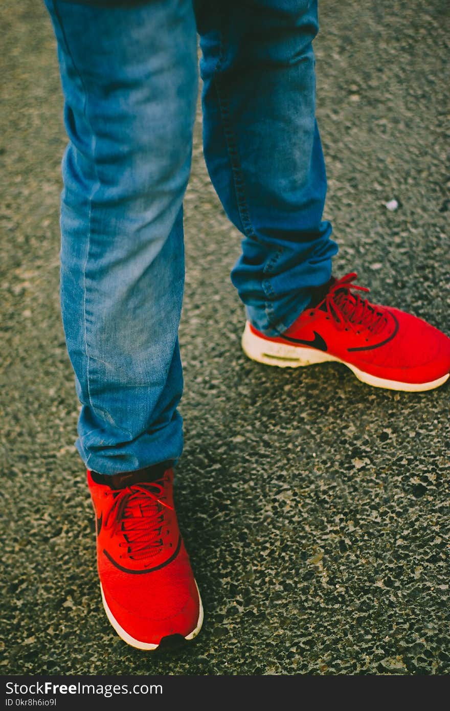 Person Wearing Red Nike Running Shoes