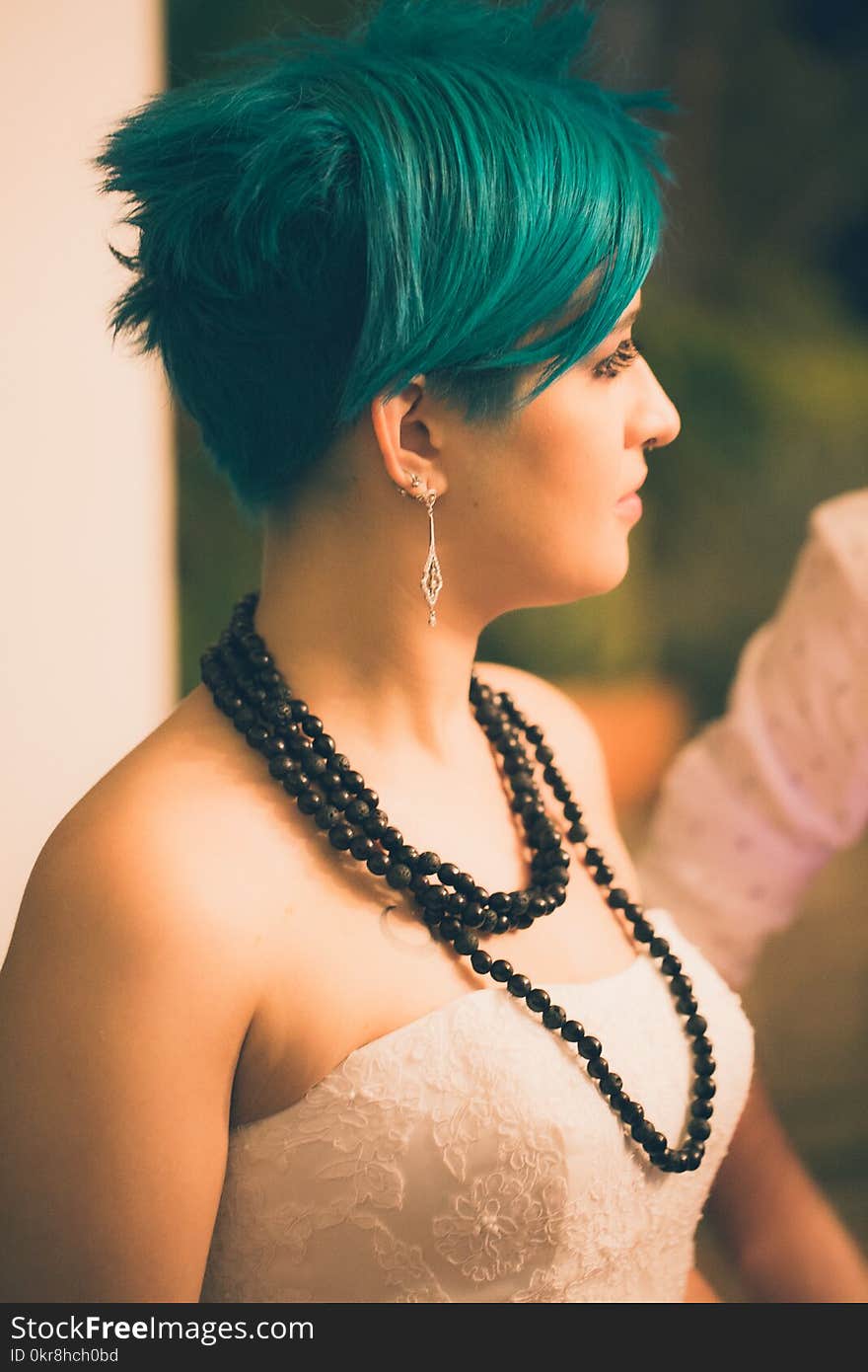 Tilt Shift Lens Photography of Woman Wearing Beaded Black Necklace