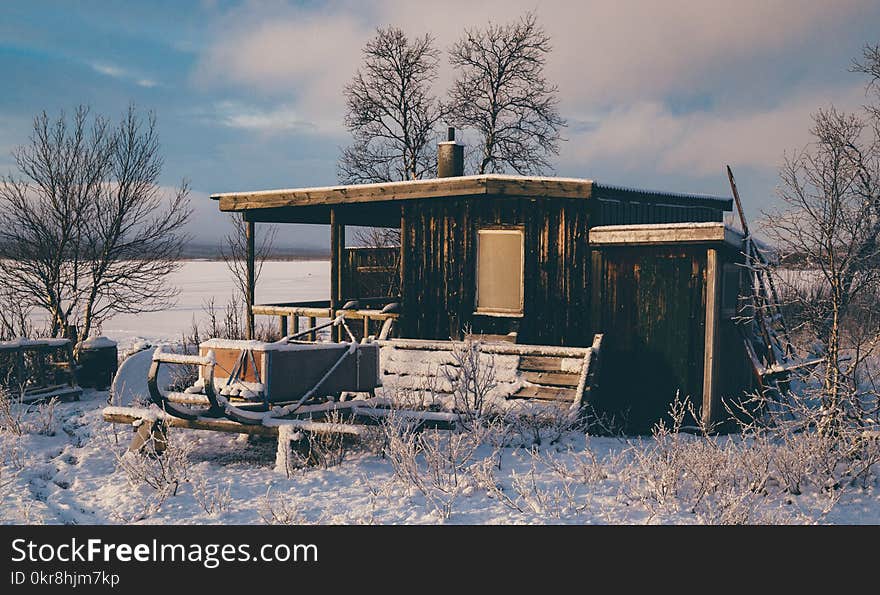 Brown Wooden Barn Surrounded by Snow