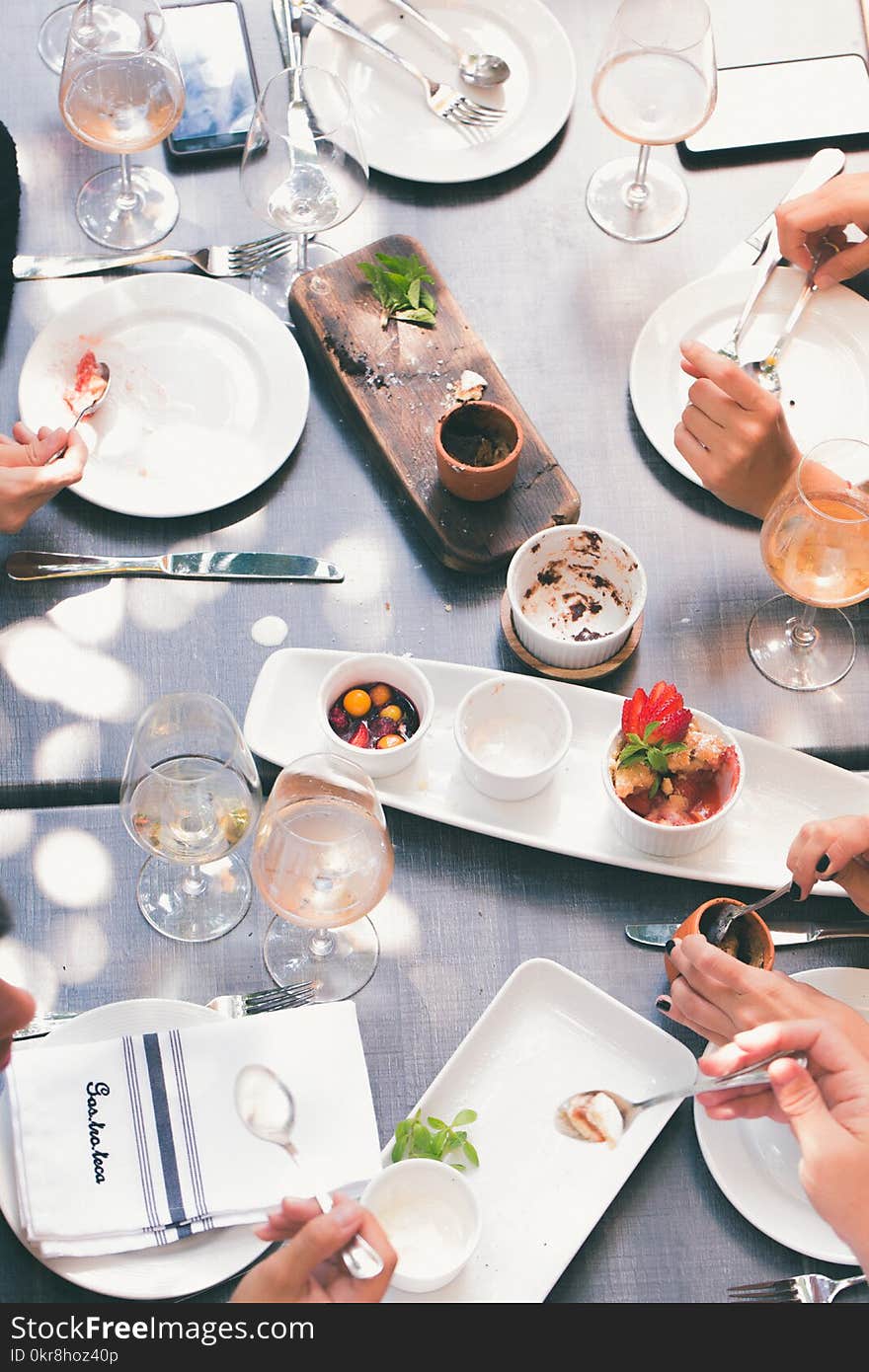 White Ceramic Plates and Bowls on Table Surface