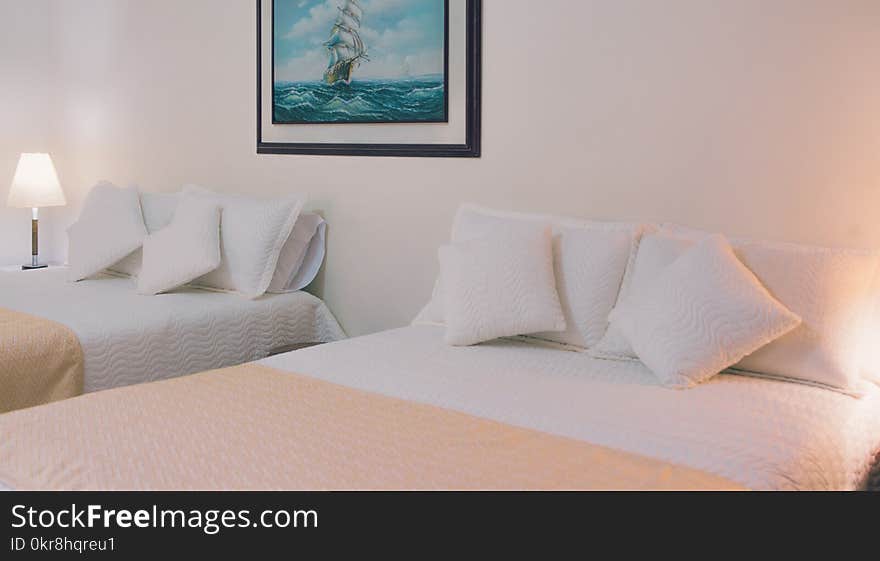 Two White Bed Mattresses Near Wall