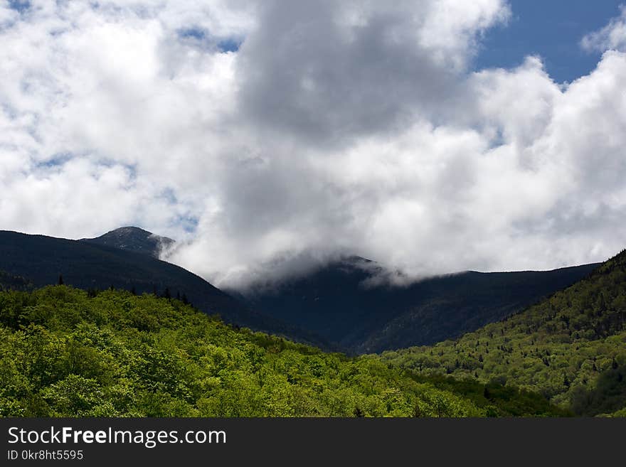 Green Hill Under White Clouds and Blue Sky